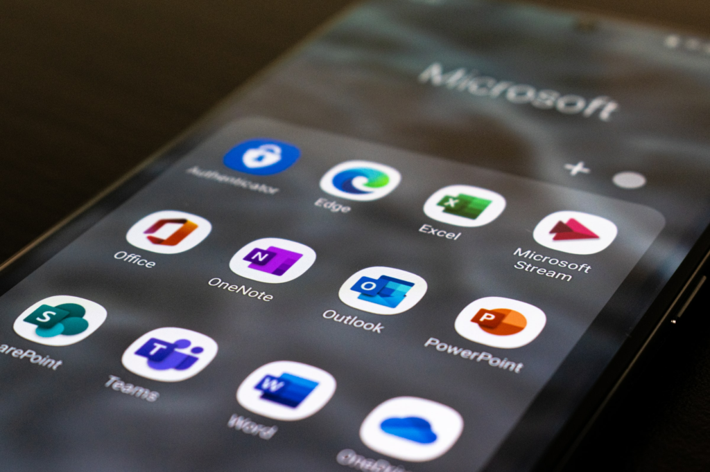 Photograph of smartphone showing icons of Microsoft apps installed.